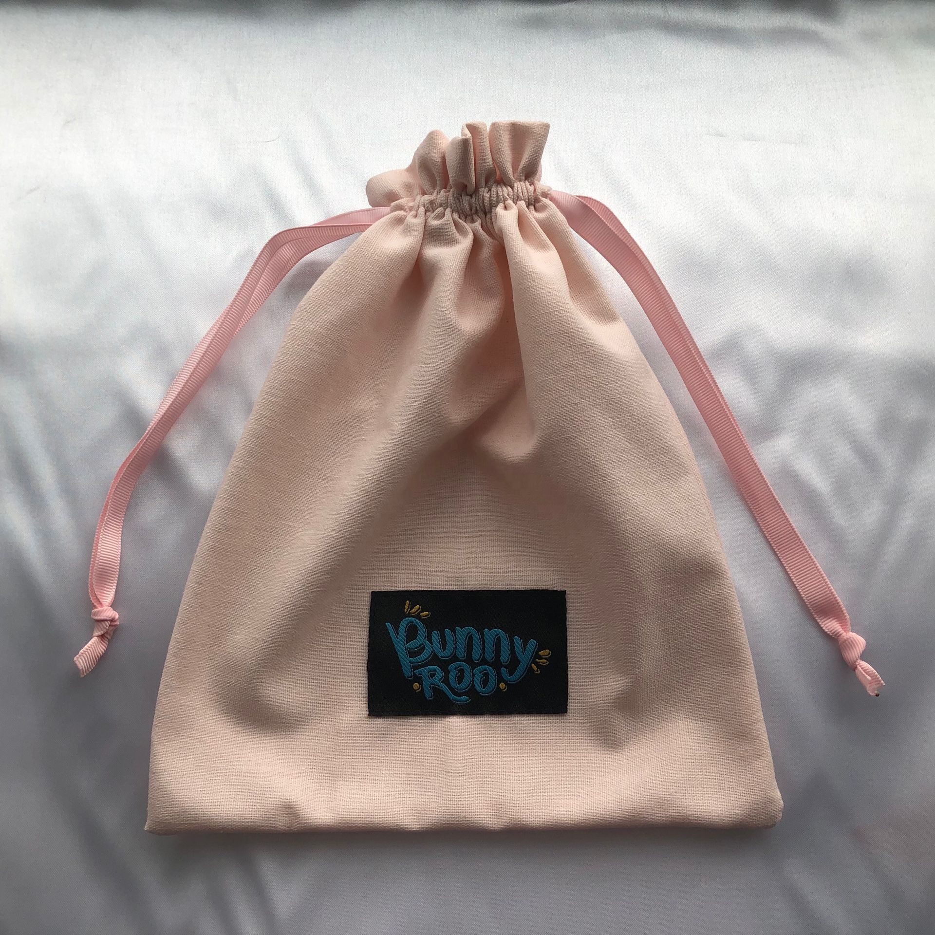 Canvas drawstring bag with custom logo for durable packaging